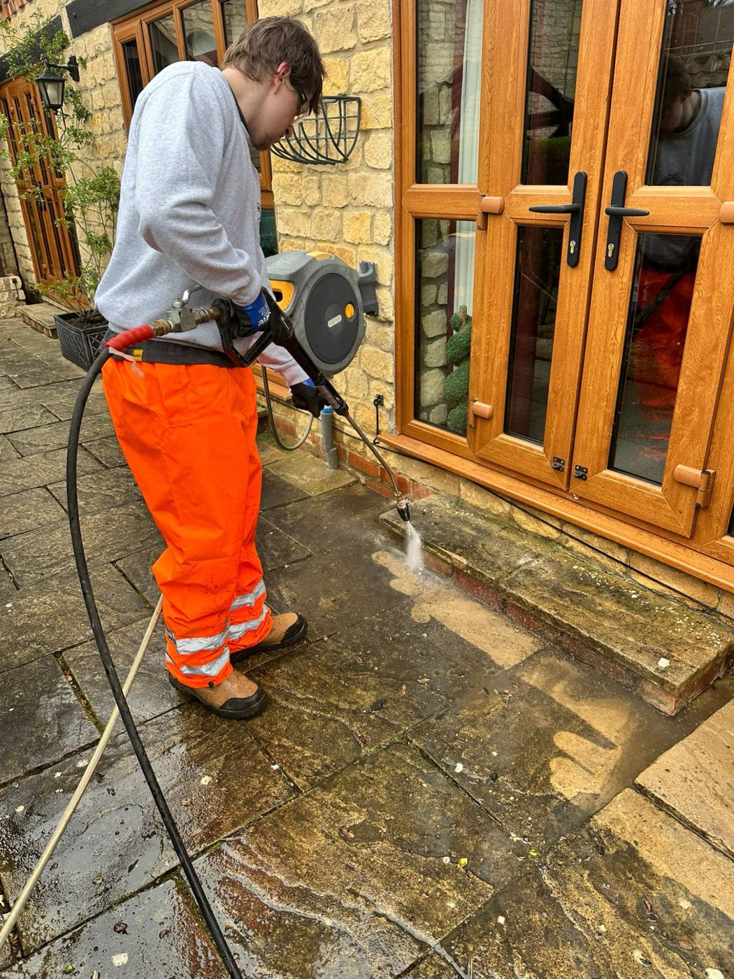 Pressure washing by patio doors